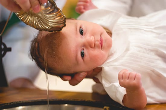 Baby in a water baptism ritual