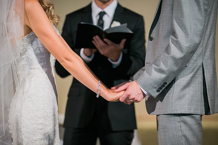 Ordained minister demonstrates how to perform a wedding ceremony