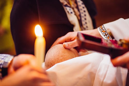 Ordained minister performs baby baptism